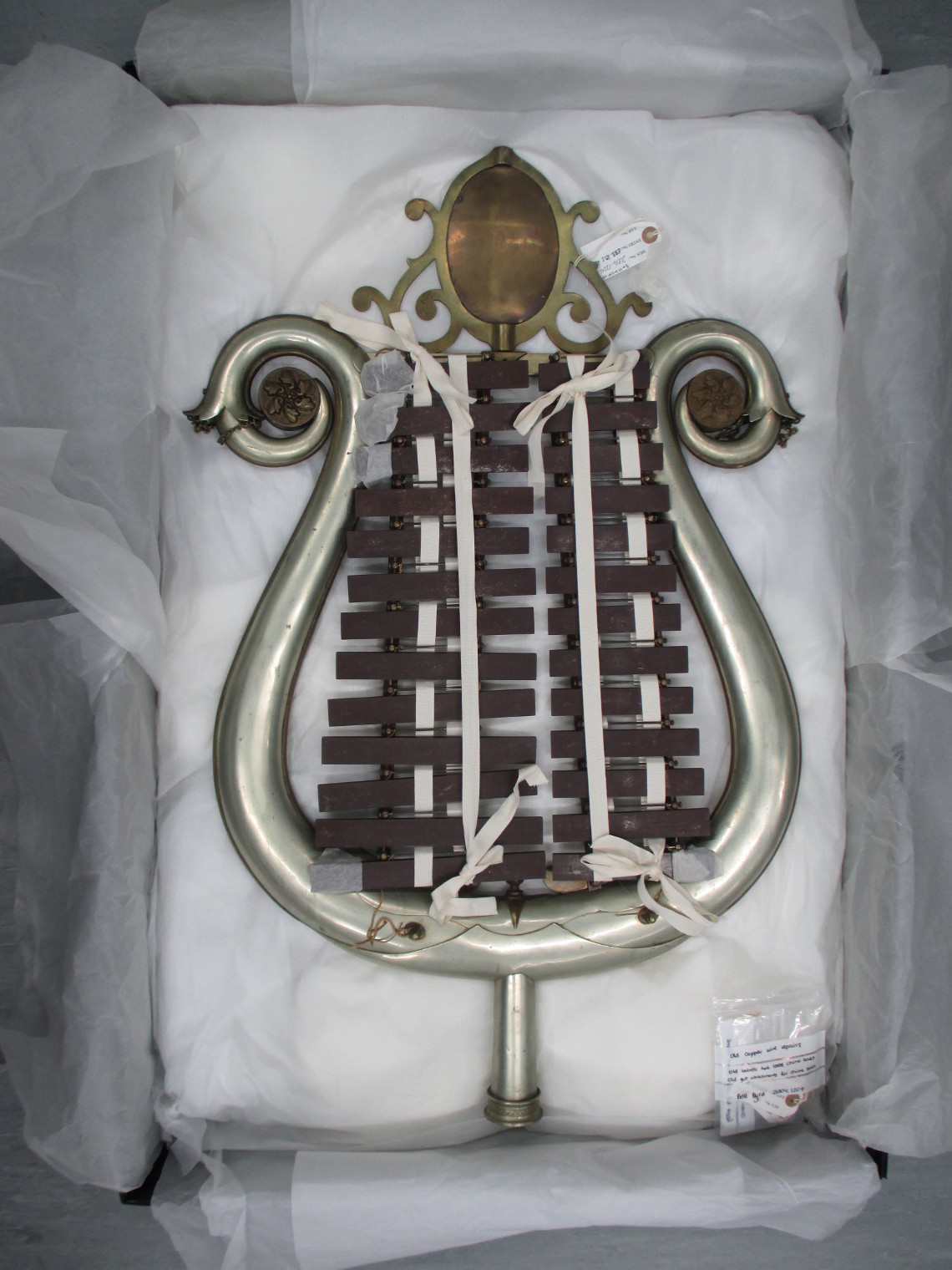 The bell lyra in its box